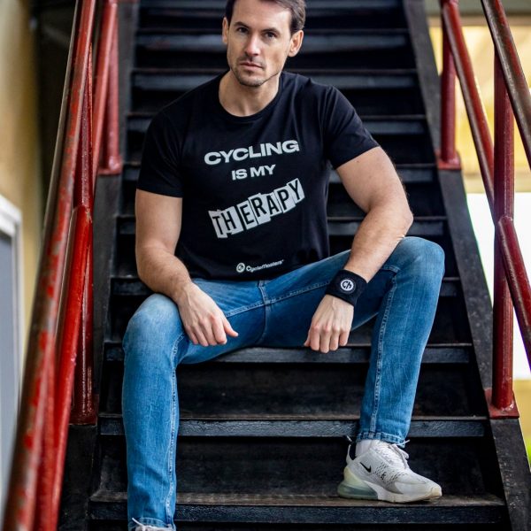 A man wears a black CycleMasters t-shirt