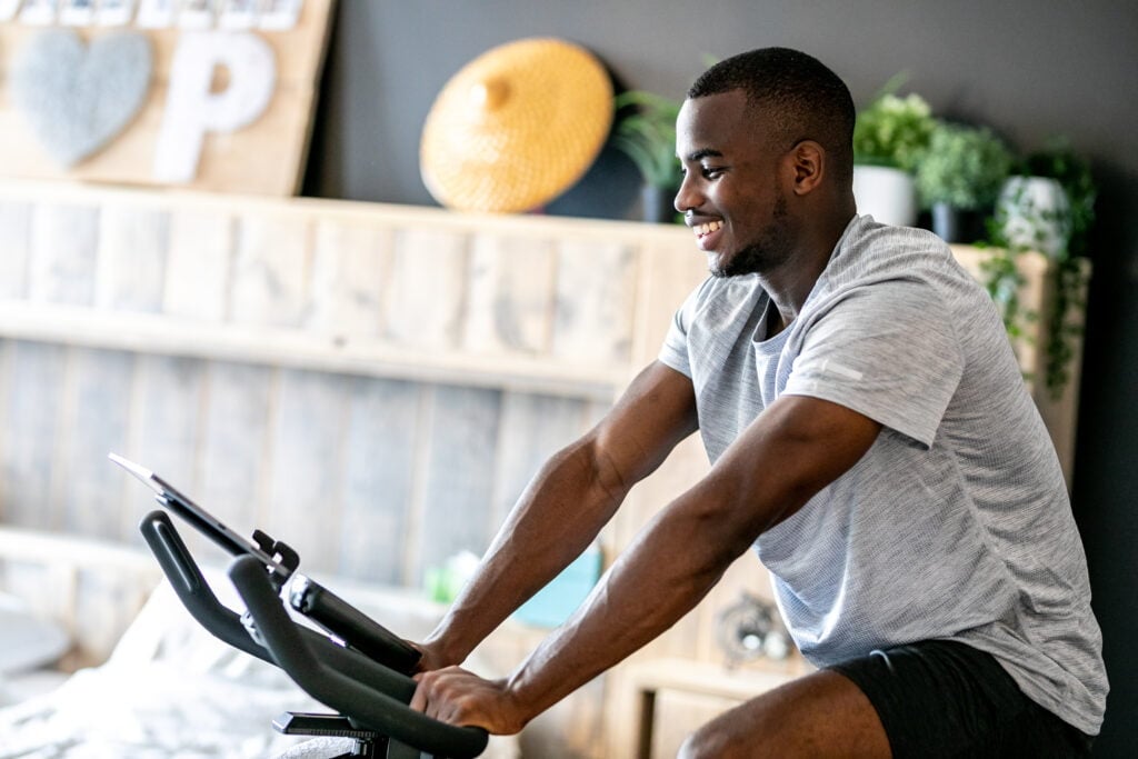 A man on a bike experiencing the benefits of indoor cycling