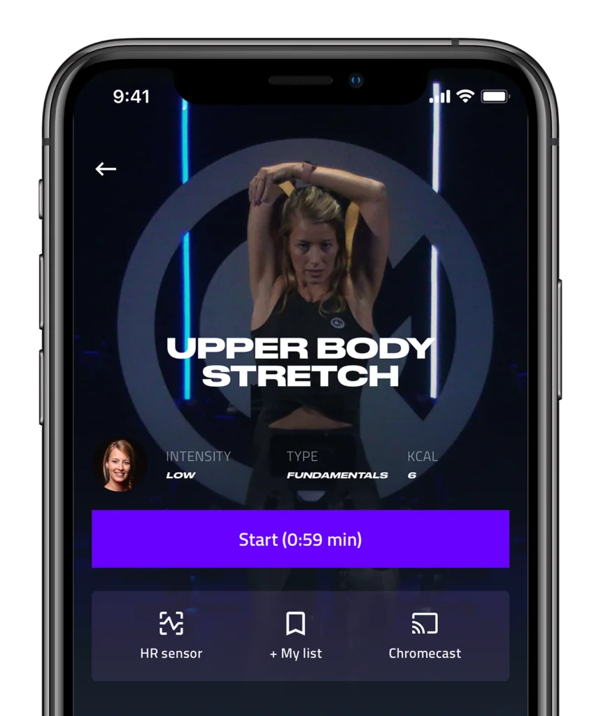 A smartphone displaying a fitness app with a video of a woman doing an upper body stretch. the app screen includes options for intensity, workout type, calorie info, and connectivity features like chromecast.