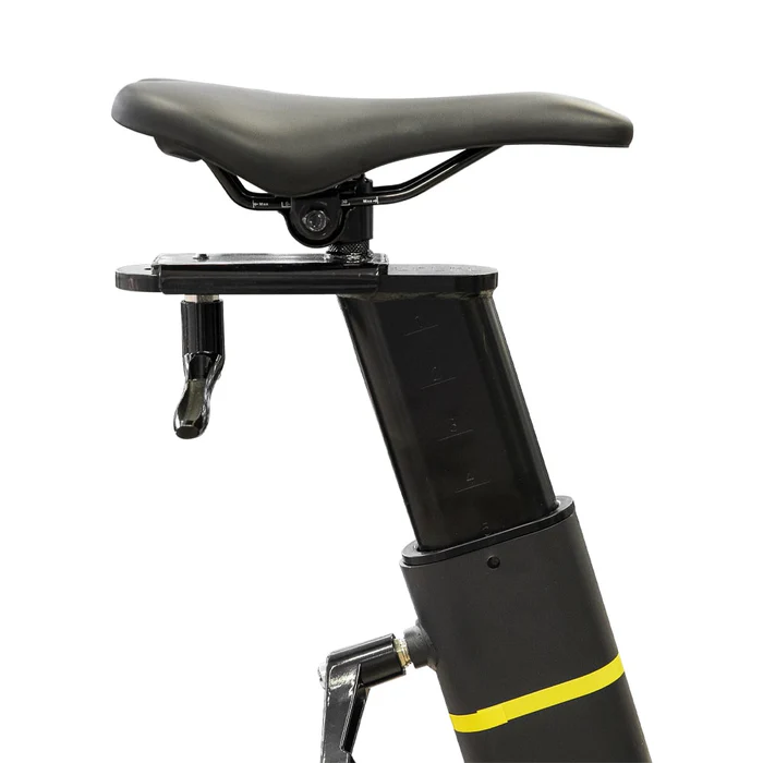 Close-up of a black bicycle saddle mounted on an adjustable seat post, with a visible quick-release lever. the post is attached to a part of the bike frame with a yellow accent.